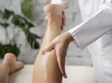 A woman receiving a leg massage during a body exfoliation treatment in Brisbane.